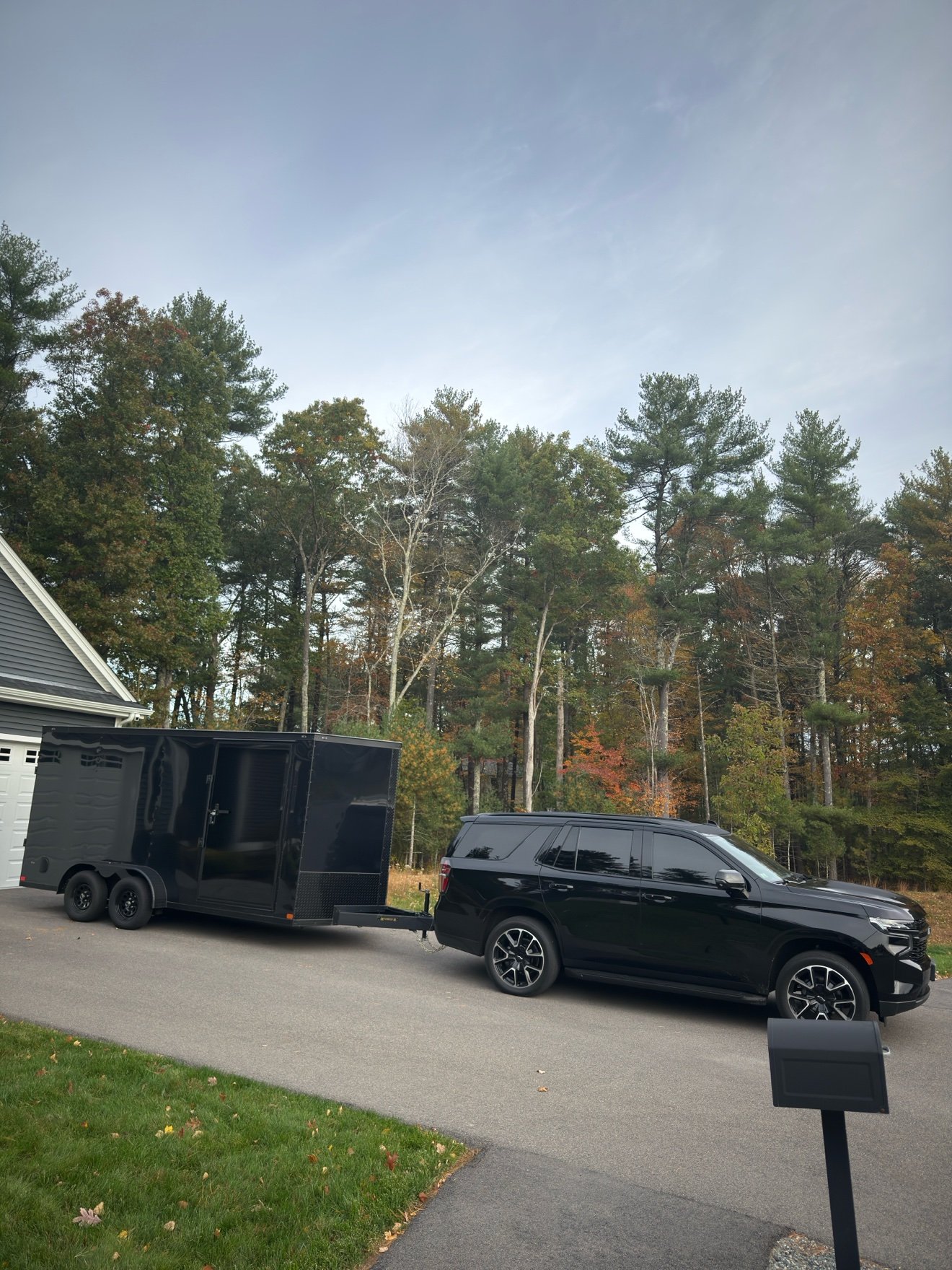 Blackrock's black Tahoe hitched to the black enclosed dual-axle trailer — the rig the business is named for